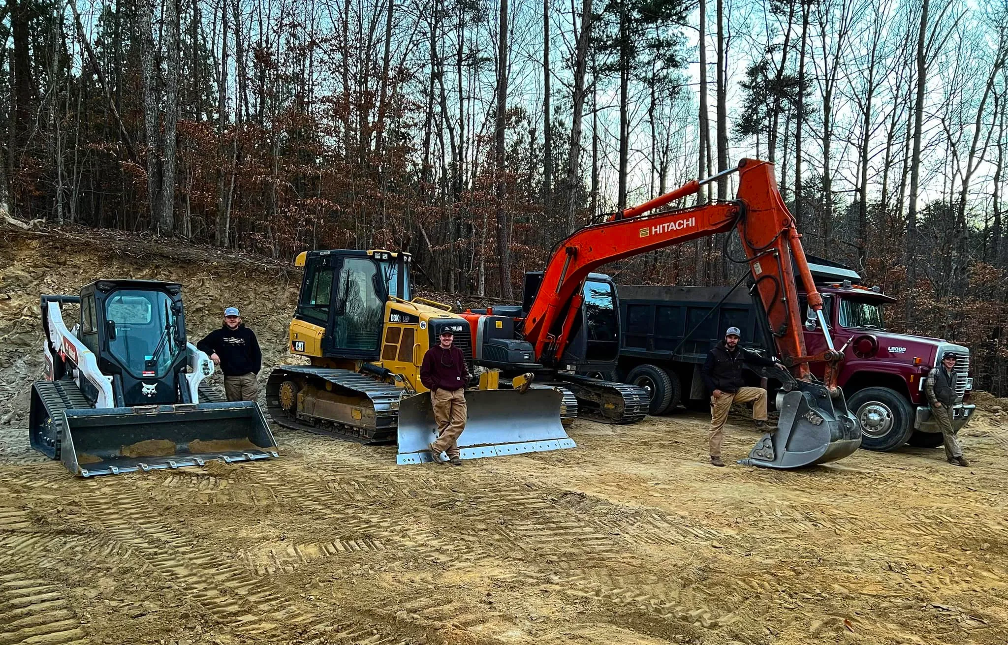 The Wallburg Dirt Worx crew with a skid steer, bulldozer, excavator and dump truck