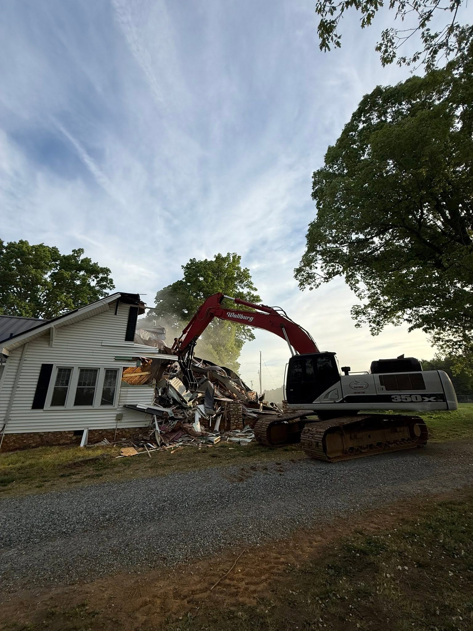 Excavator tearing down a house in the North Carolina Triad