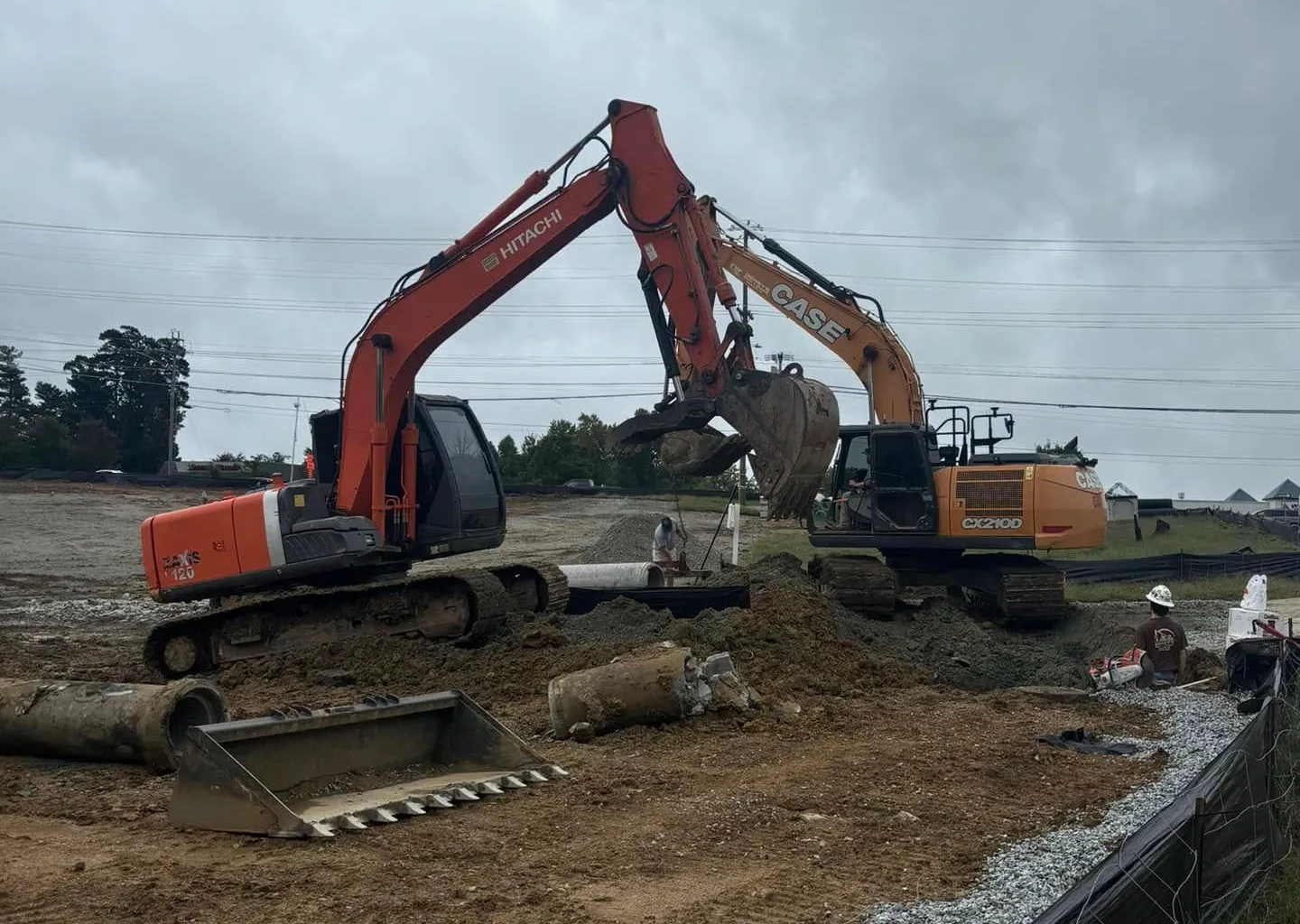 Two Wallburg Dirt Worx excavators working in tandem on a Triad site